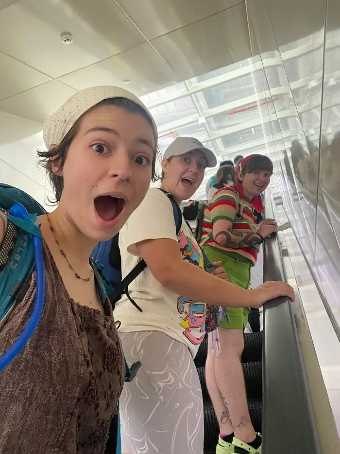 Three CET Taiwan students looking down while on an escalator