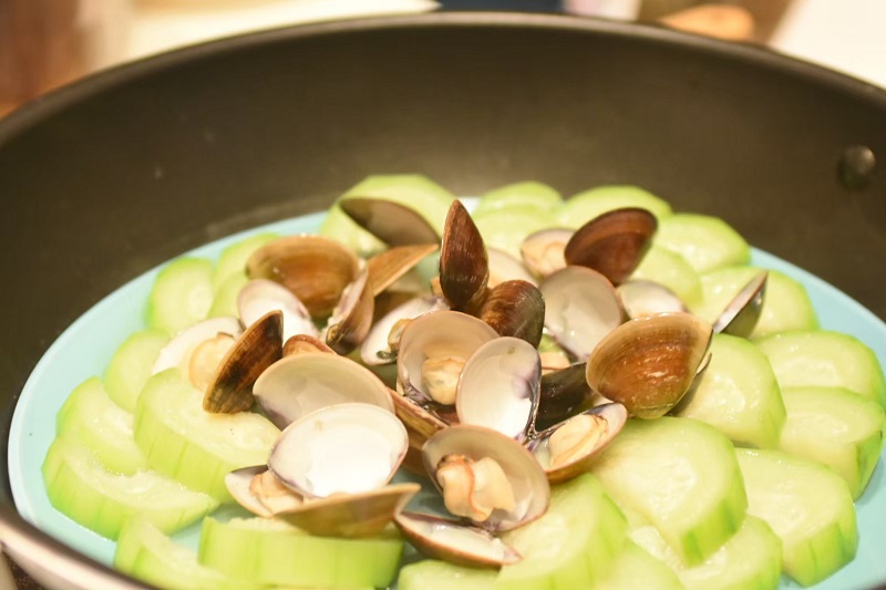 A close-up of a clam and towel gourd dish