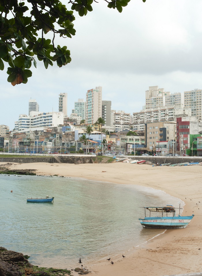 A beach in Salvador da Bahia with the backdrop of buildings 