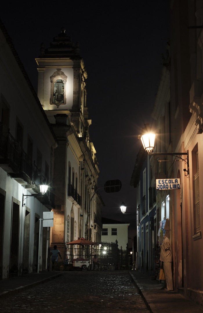 Some lamps lit up along an empty street in Salvador da Bahia at night