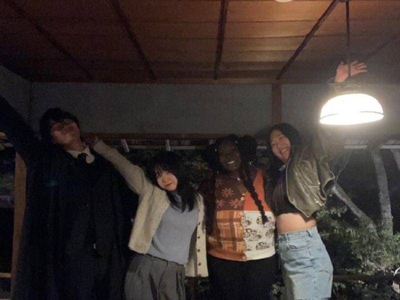 CET Japan student and her friends posing in the dark