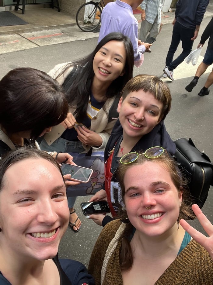 CET Taiwan students posting for a selfie while in the middle of the street