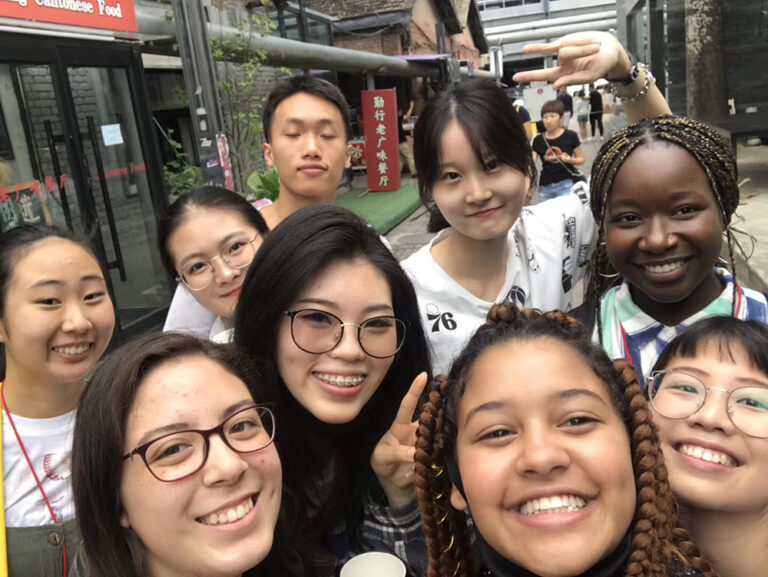students and local roommates selfie on street