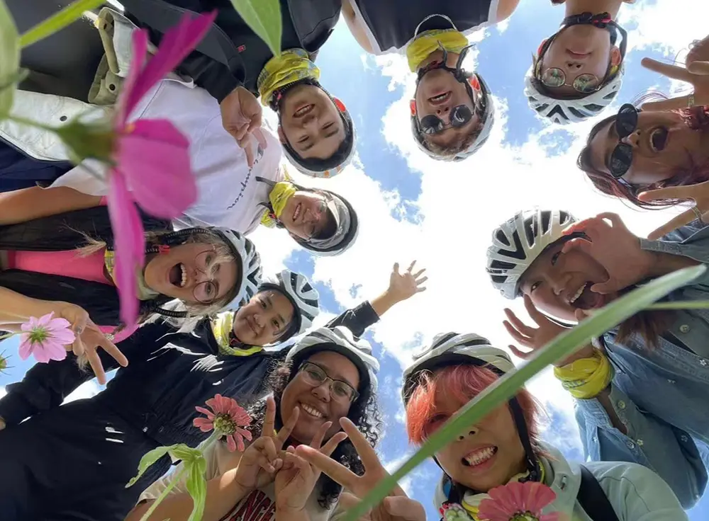 students wearing helmets looking down at camera
