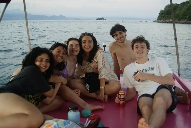CET Brazil students on a small pink boat together while on the water