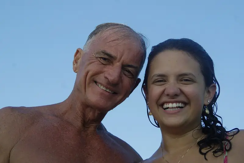 A CET Brazil student and and their guide, Marco Aurelius, wet from the water posing together