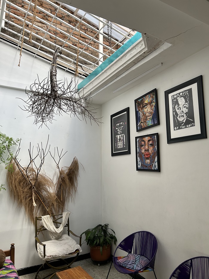 A room with chairs and black art at the BlackGround Lab in Cali, Colombia