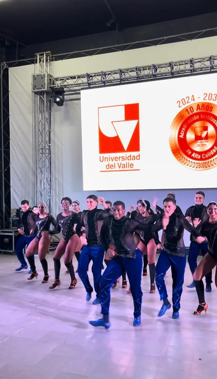 A group of students dancing together in sparkly costumes at the Universidad del Valle in Colombia