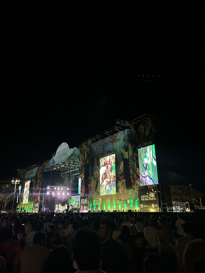 A stage lit up with lights and large screens at night at the Festival Petronio Álvarez in Colombia