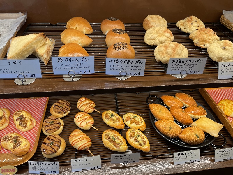 An array of different baked goods on display in a café called Charmy One in Osaka, Japan