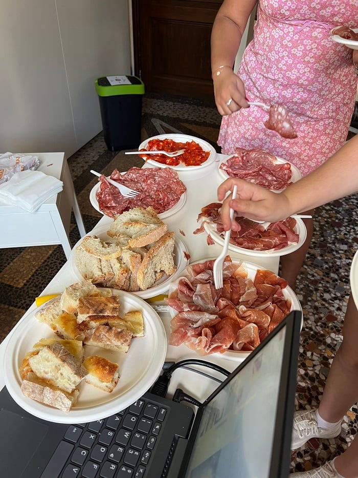 A table with different cuts of bread and Italian meat