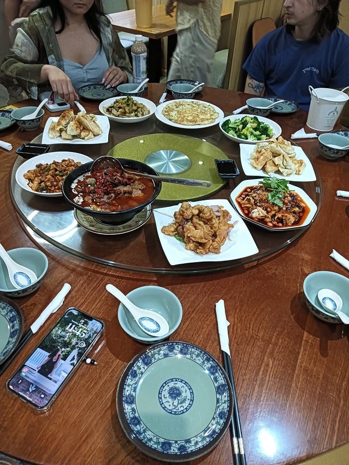 A large table with shareable foods including some authentic Shanghai cuisine