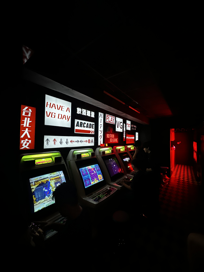 A arcade lit up with signs and screens in  Taiwan