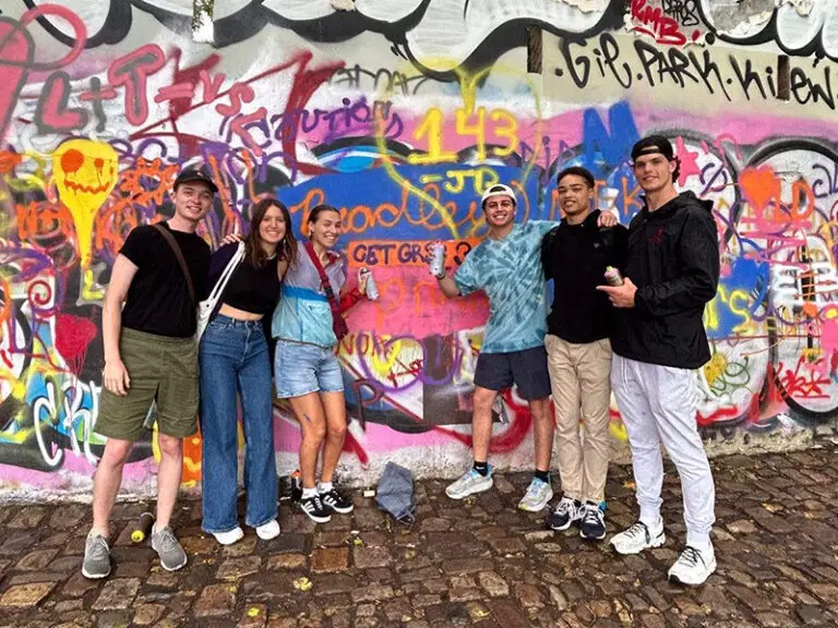 students in front of street art