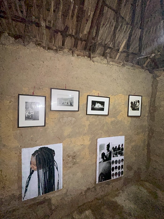 Multiple photos and framed photos of braids or locs in hair on a wall in San Basilio de Palenque