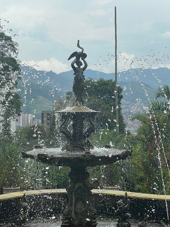 A close up of a beautiful fountain outside of El Castillo Museum in the garden area in Medellín, Colombia