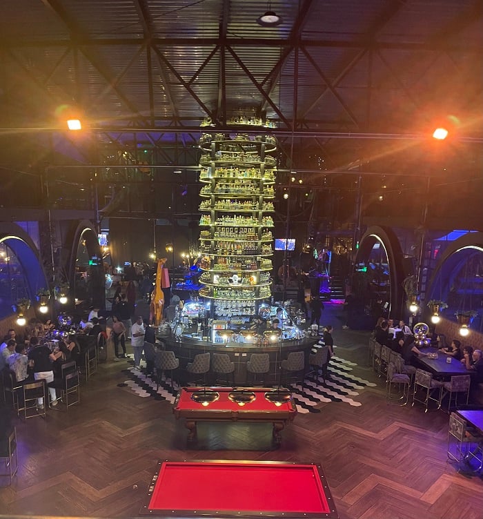 The inside bar area of the large building Super Bowling with people drinking and dining