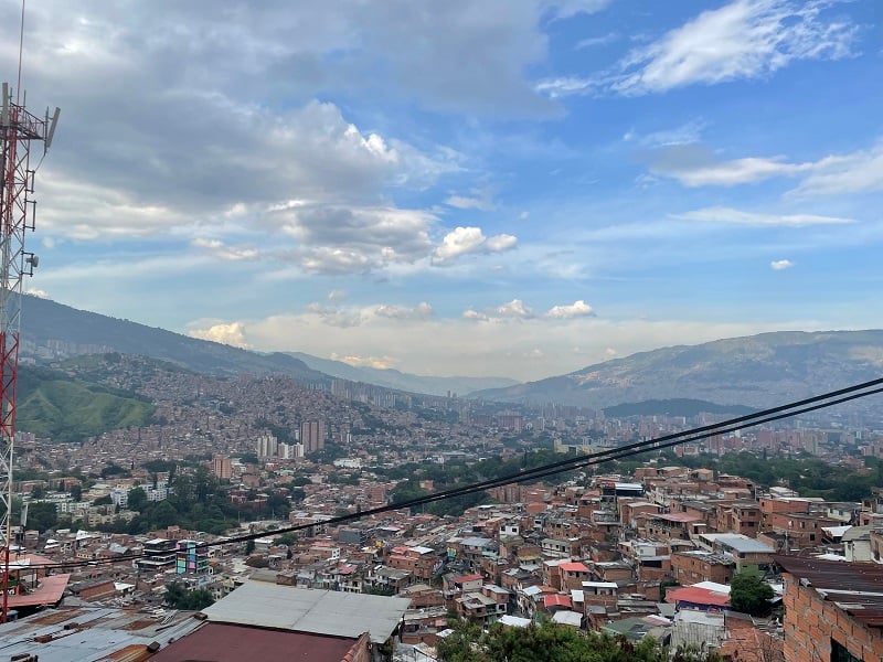 A view of mountains and buildings within the neighborhood of Comuna 13 in Medellín , Colombia