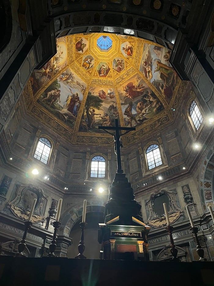 A cross and candles within the Cappellee Medicee in Florence, Italy