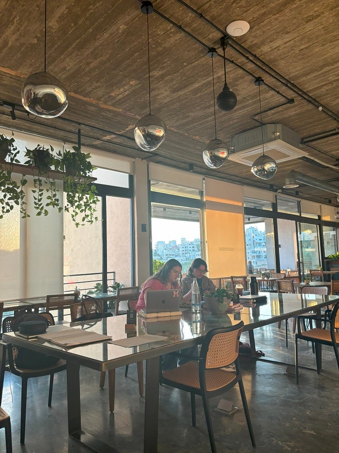 Two people sitting at a large table at a café called Manara in Amman, Jordan 