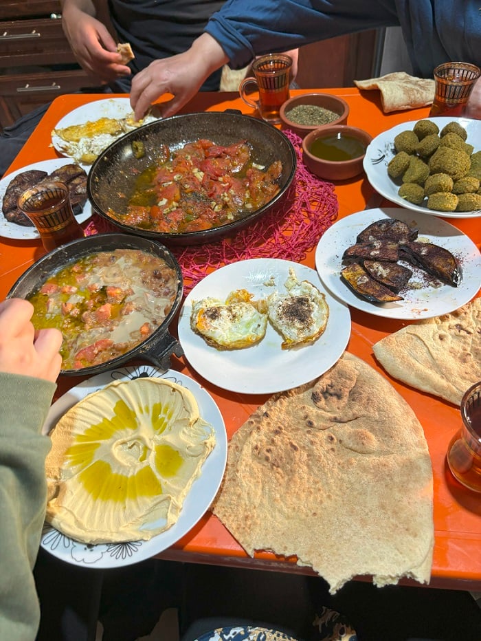 A table with traditional Jordanian food including many dips and bread