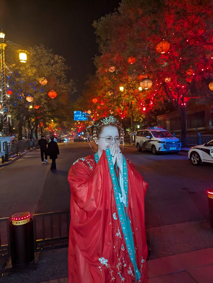 A CET Shanghai student dressed up in  traditional Tang Dynasty clothing while standing by a street with lanterns in Xi'An