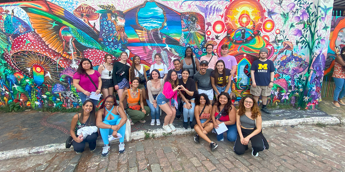 group of students in front of street art