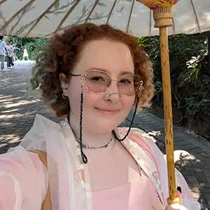 heashot of woman holding umbrella