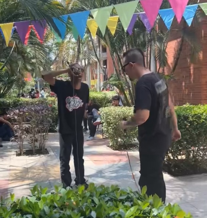 Two men having a rap content outside of La Universidad Autónoma del Occidente in Cali, Colombia