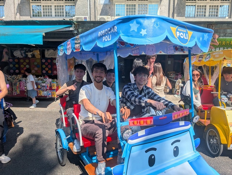 A group of CET Taiwan students riding 4-person electric carts
