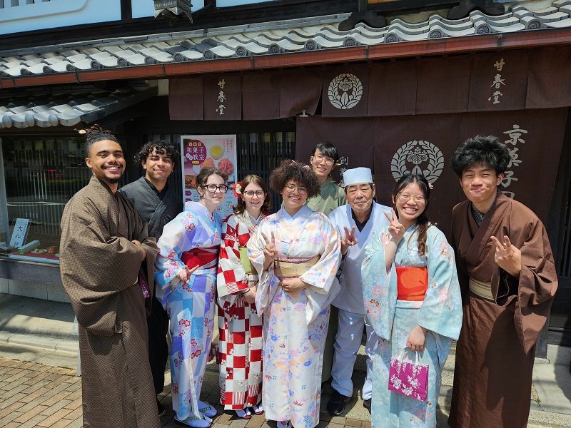 A group of CET Japan students smiling and posing while wearing traditional Japanese clothing