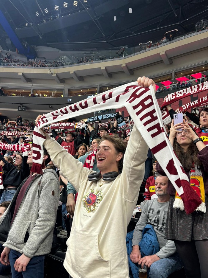 A CET Film Production at FAMU student holding up a scarf within a crowd at a Sparta hockey game in Prague