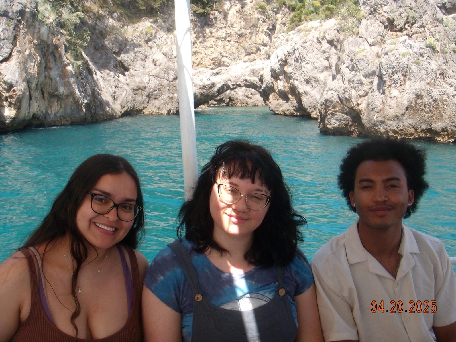 A group of CET Florence students smiling while on a boat in Amalfi Coast on a sunny day