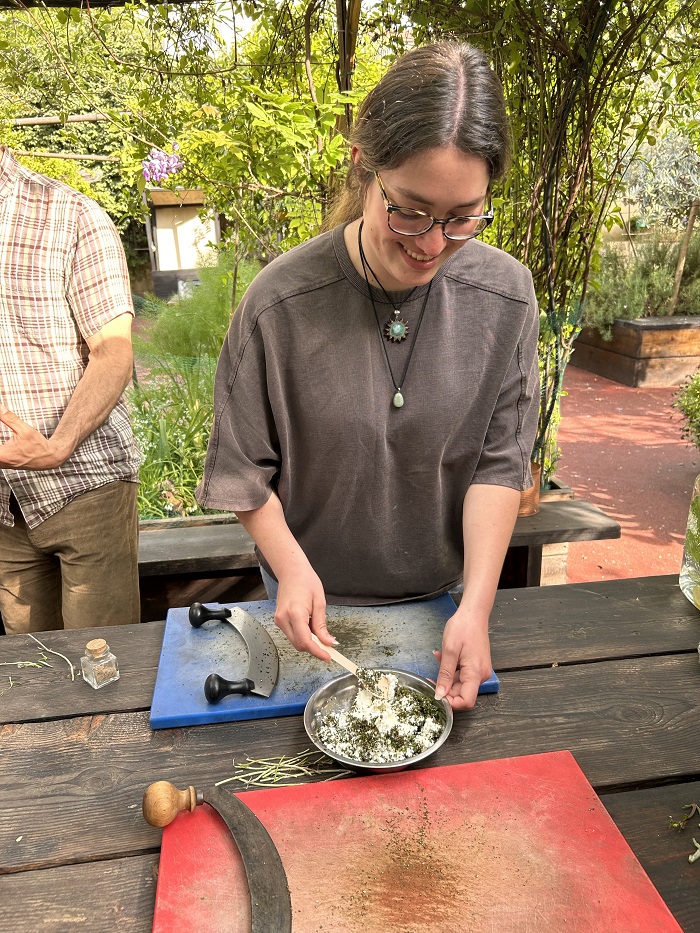 A CET Florence student mixing a bowl of ricotta and fresh herbs outside
