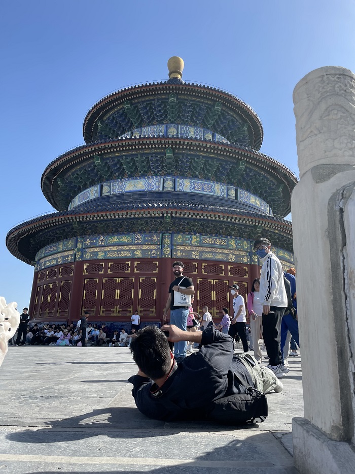 Study abroad students in Beijing posing in front of the Temple of Heaven on a cloudless day