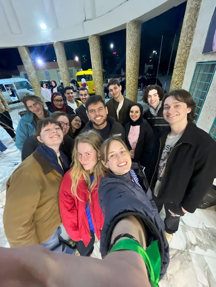 A group selfie of CET Jordan students and local neighbors outside