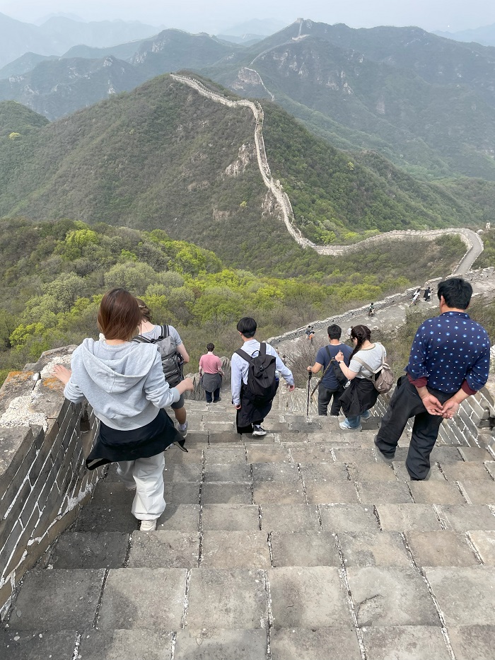 A group of students hiking down a part of the Great Wall of China in Hebei