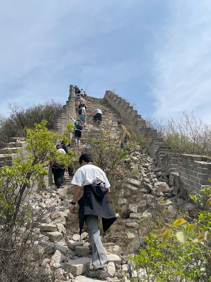 A group of students hiking up a part of the Great Wall of China in Hebei