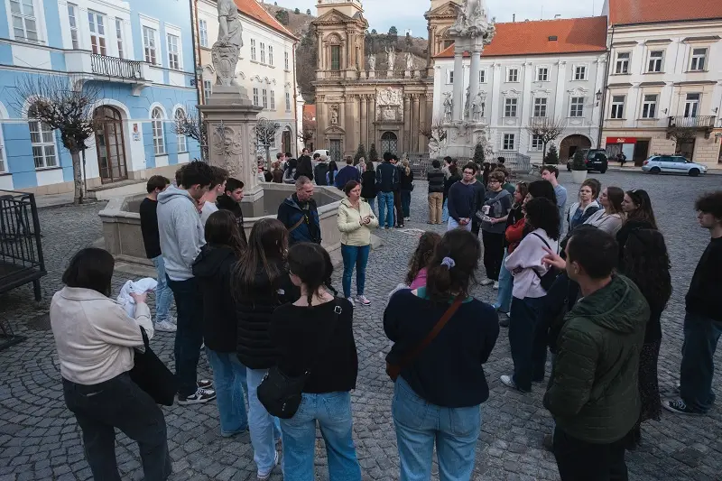 A group of CET Prague students and staff standing around in a circle while on a walking tour in a town square in Mikulov