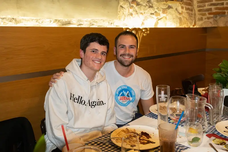 Two CET Prague students smiling while sitting at a table in a restaurant with traditional Polish food