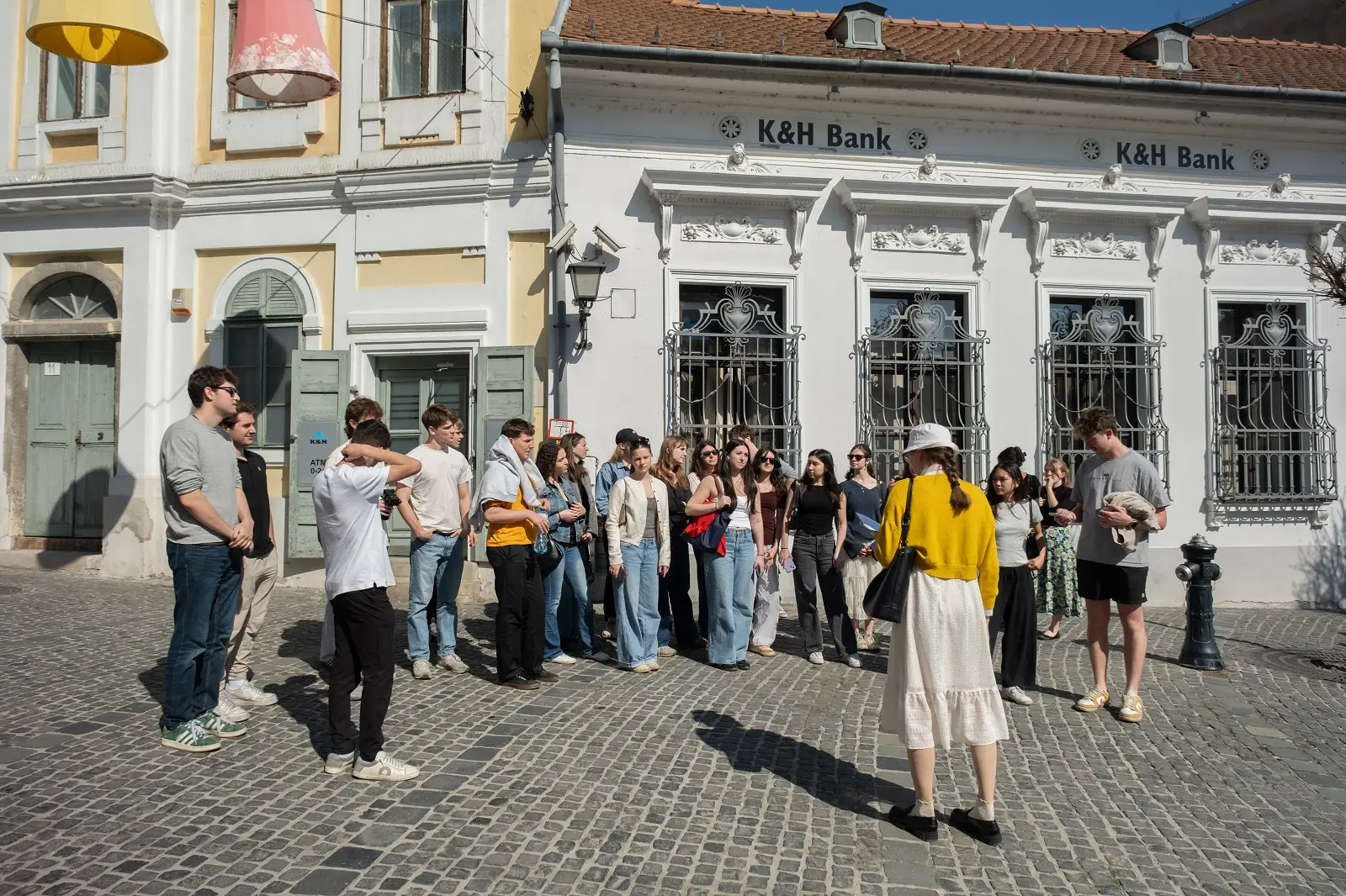 A group of CET Prague students standing in the street while on a walking tour