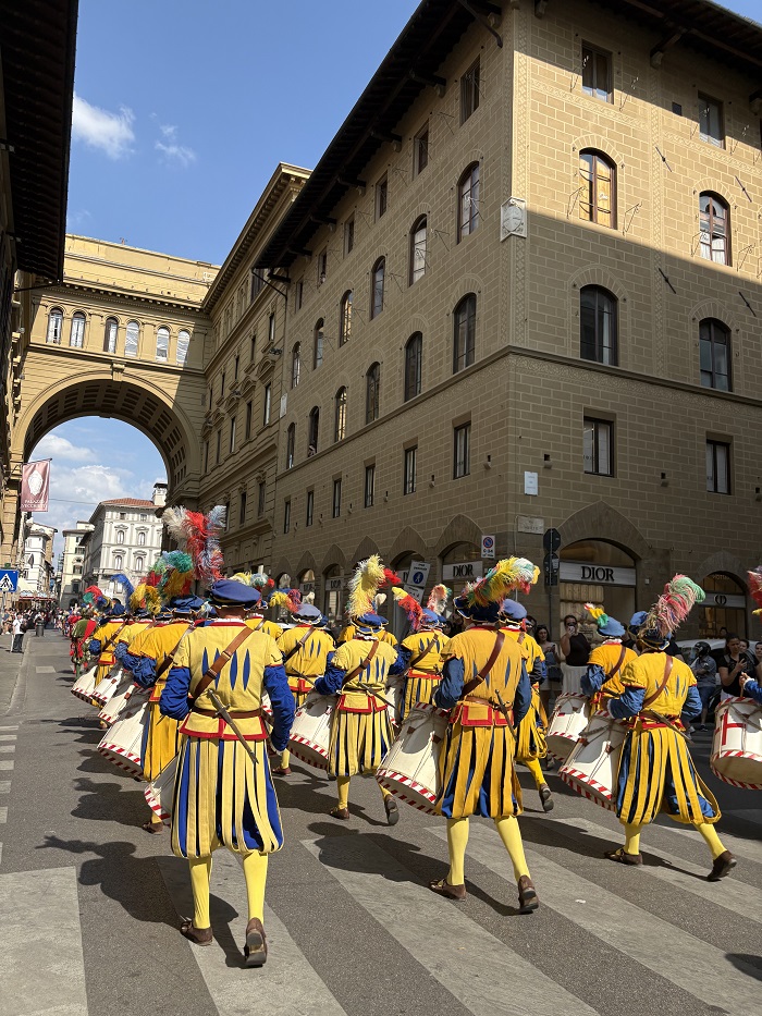 Rows of people marching in costumes for the Festa di San Giovanni festival in Florence, Italy during the day