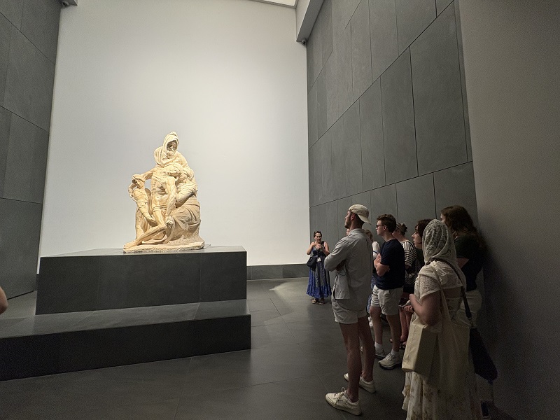 People starring at an art piece in Museo dell’Opera del Duomo in Florence, Italy