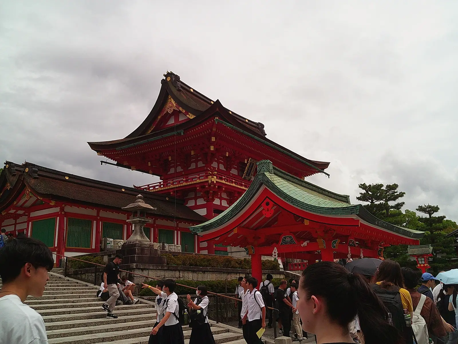 The main temple with people walking alongside stairs in Kyoto, Japan