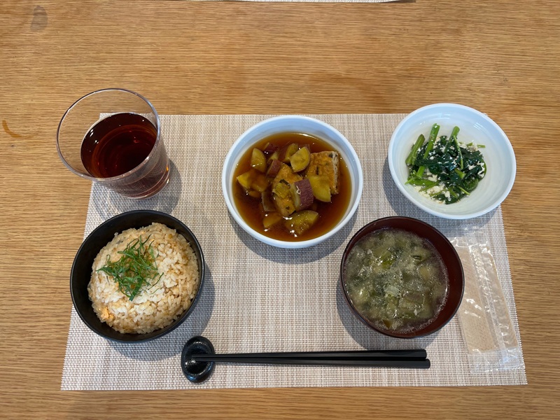 A tray of traditional Japanese foods including soups, vegetables, and more