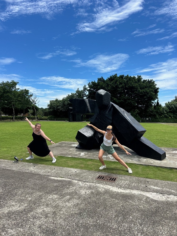 Two CET Taiwan students posing by an artwork outside of the Juming Museum