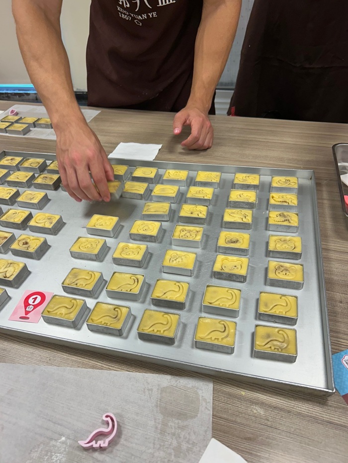 A tray with rows of freshly made pineapple cakes