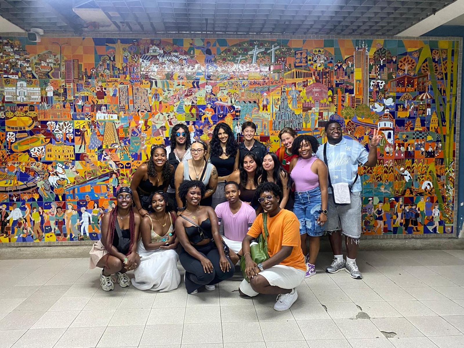 A group of CET Colombia students posting together in a large mural