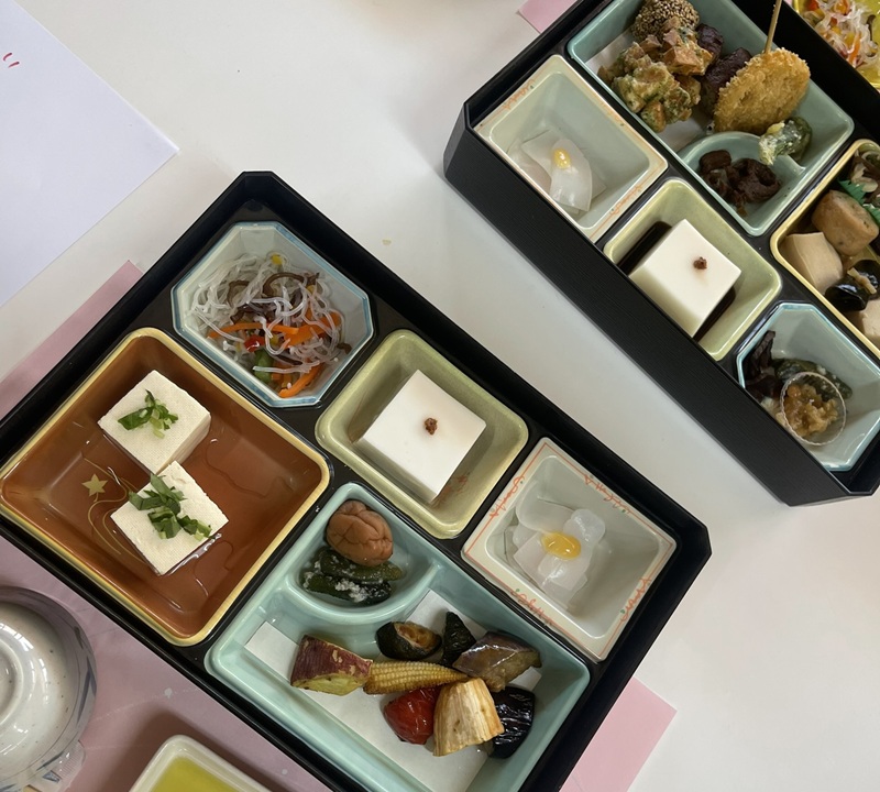 Two boxes of an array of an ascetic Buddhist cuisine excluding meat, fish, dairy, eggs, and vegetables