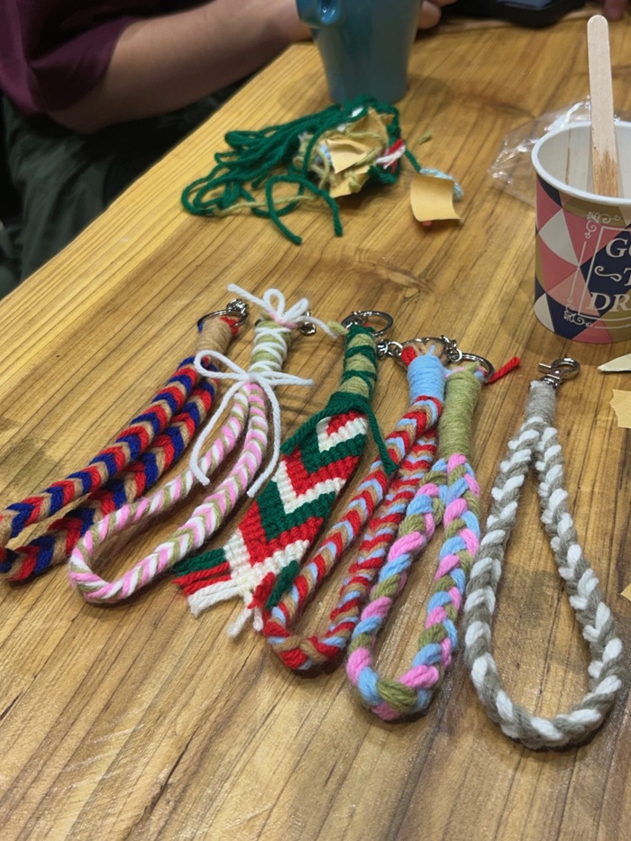 Six weaved keychains laid out on a table